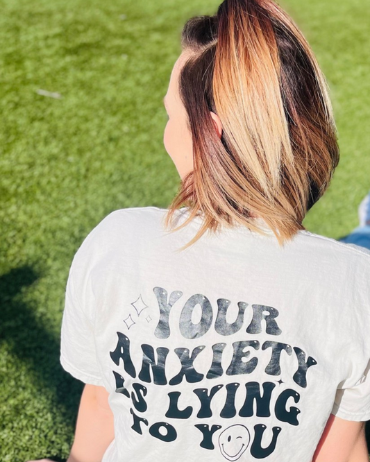 Show how strong you are with this comfortable graphic tee. Its neutral top and black design go well with any outfit, and the relaxed fit pairs perfectly with biker shorts. Feel confident knowing anxiety isn't controlling your life.