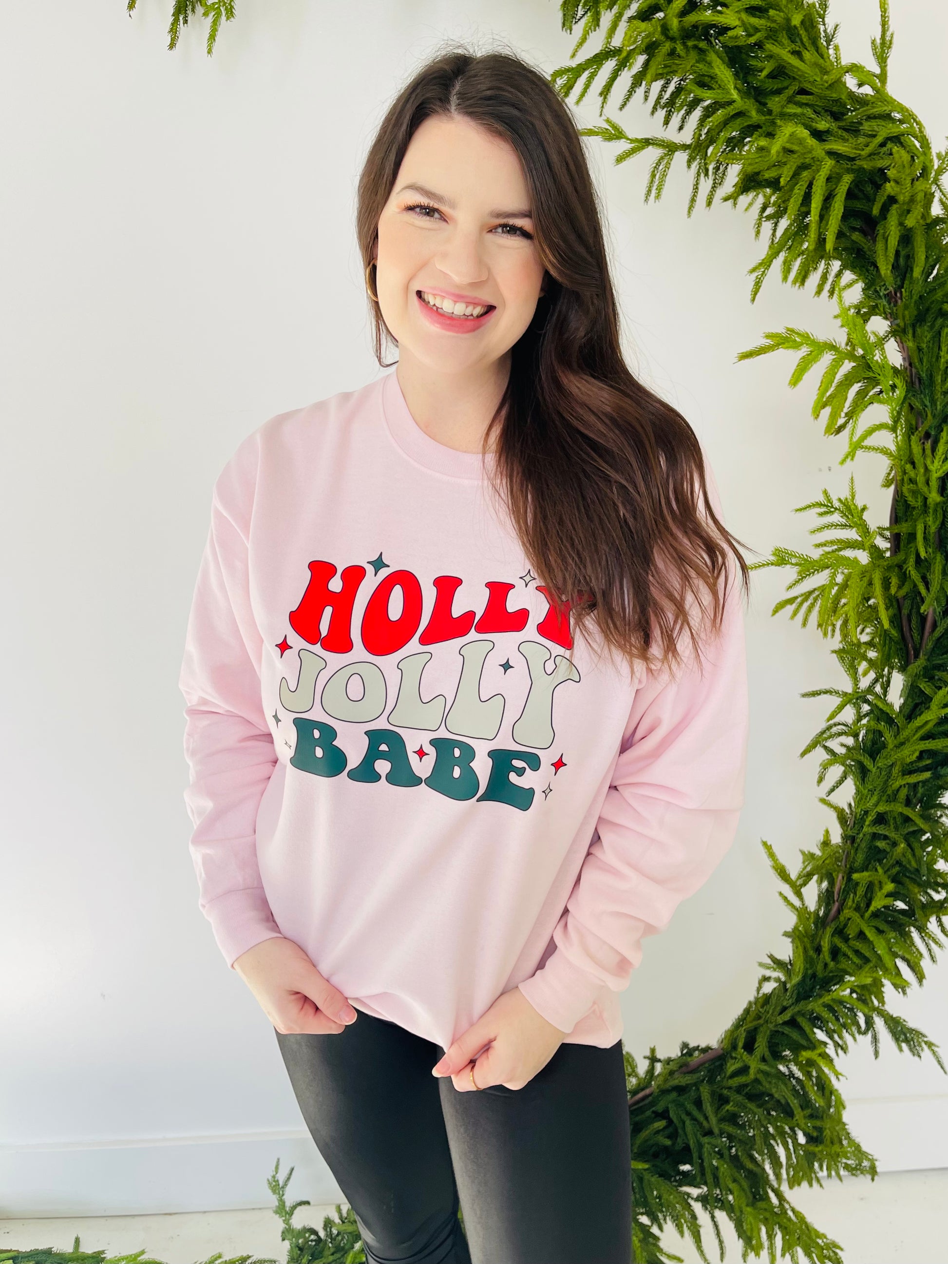 Are you a holly jolly babe this time of year? This sweatshirt is calling your name if so! This fun crewneck sweatshirt is a soft, light pink color with a vibrant retro looking graphic. 