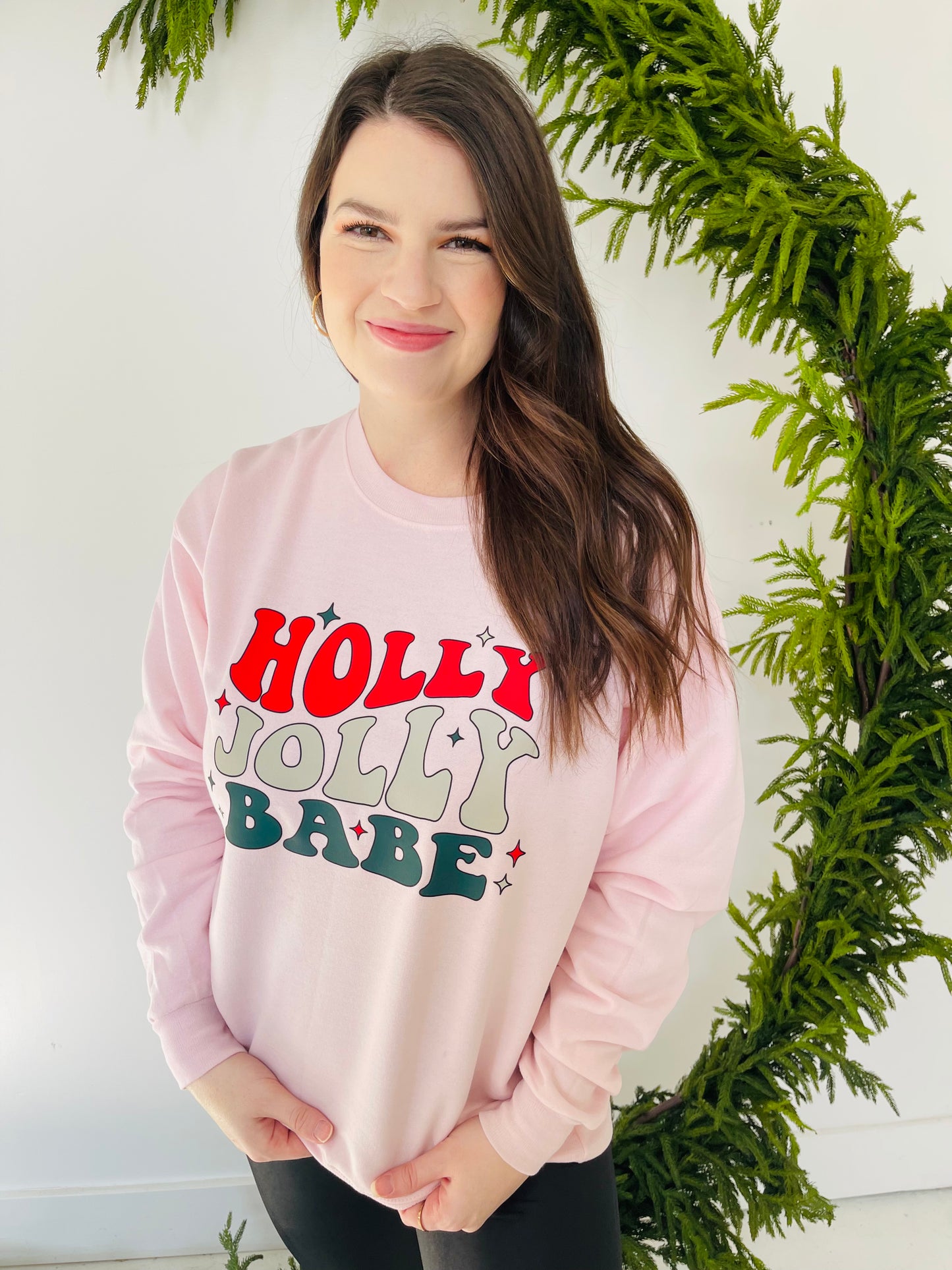 Are you a holly jolly babe this time of year? This sweatshirt is calling your name if so! This fun crewneck sweatshirt is a soft, light pink color with a vibrant retro looking graphic. 