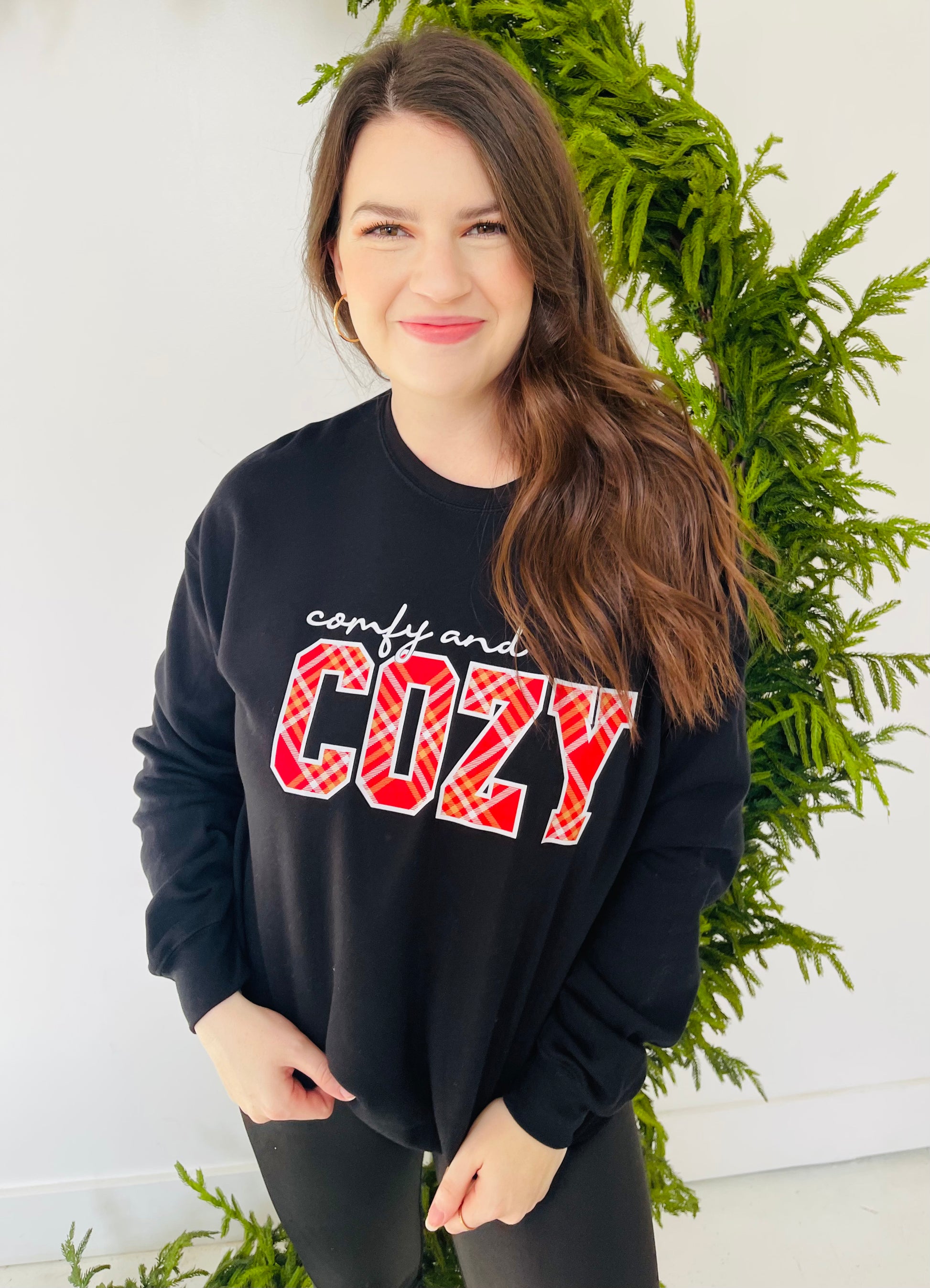 Cozy, comfy, need! This sweatshirt is a black crew neckline with a white, plaid, and gold graphic. This is great to pair with leggings for a Holiday party or to throw on at night during the Holidays!